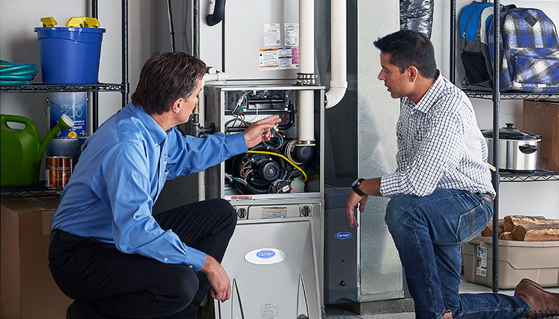 HVAC technician evaluating a furnace for repair or replacement in Orem