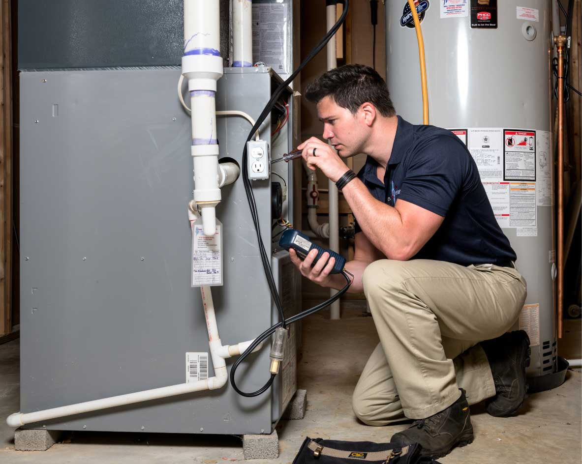HVAC technician performing a furnace tune-up in Orem