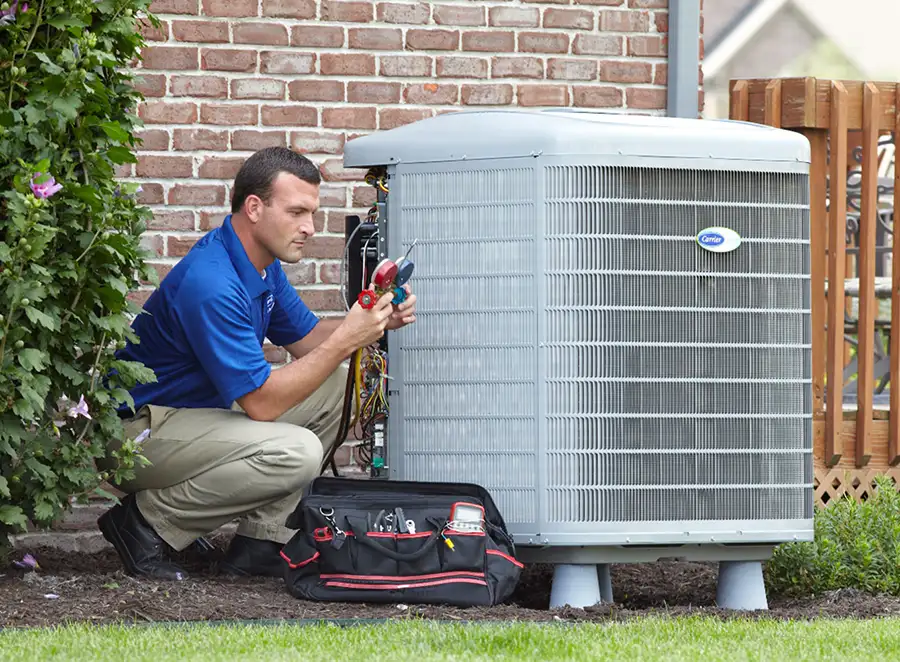 HVAC technician inspecting an outdoor air conditioning unit in Orem