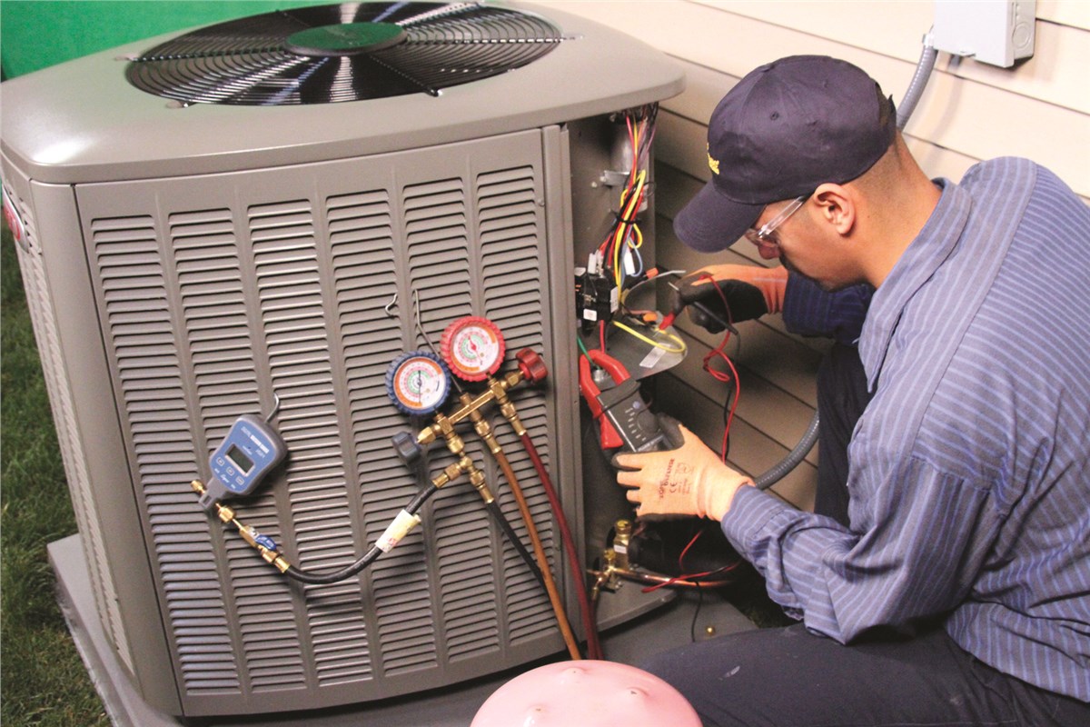 HVAC technician testing an outdoor air conditioning unit in Orem